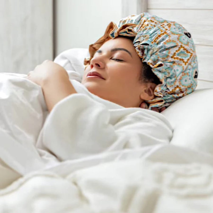 Woman sleeping peacefully with patterned satin bonnet for curly hair protection