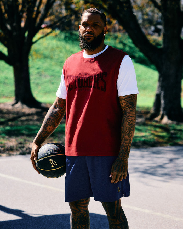 Deep red sleeveless tank top with white short sleeves and text graphic on chest.
