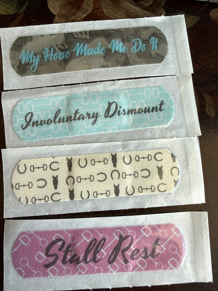 Printed equestrian bandage strips with teal, purple, and black lettering