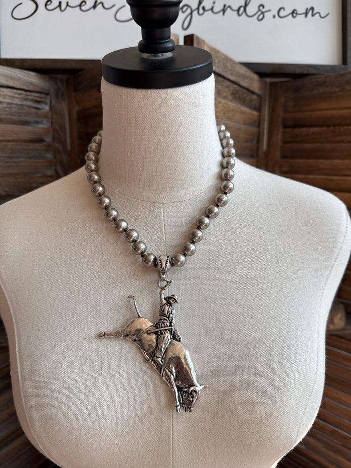 Silver-tone bead link statement necklace with bull rider pendant on mannequin