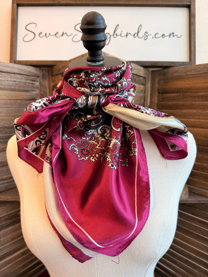 Paisley wild rag scarf draped on mannequin, maroon print with satin-like solid reverse