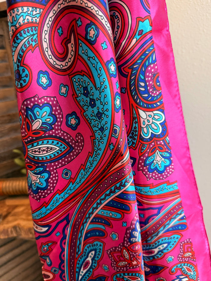 Paisley wild rag scarf in bright pink, teal, and blue with decorative border