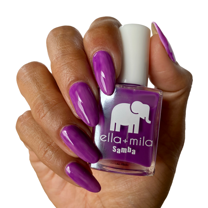 Chicha neon purple nail polish on a deep skin tone, hand holding the bottle
