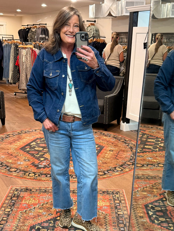Dark wash denim jacket, front view with button front and flap pockets