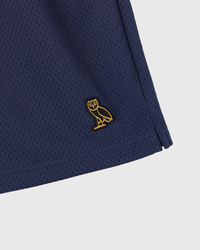 Navy mesh shorts with gold owl embroidered logo on thigh.