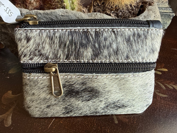 Black-and-white cowhide coin purse with two zippers and brass pull ring