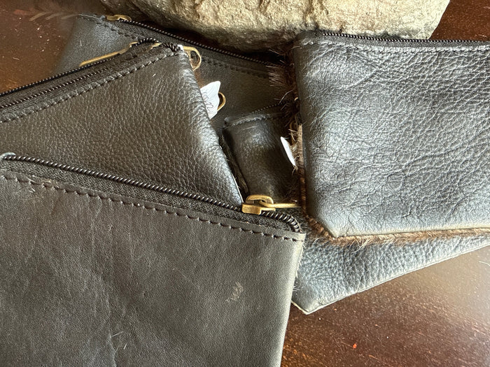 Double-zip cowhide coin purse with stitched edge and brass zipper tabs
