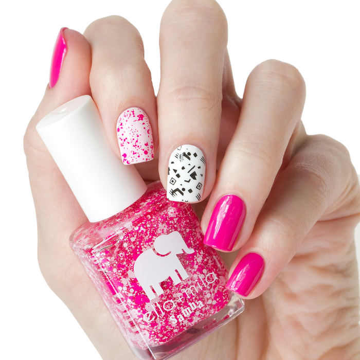 Congo Bongo pink confetti glitter accent nails with a hot pink manicure, holding the bottle