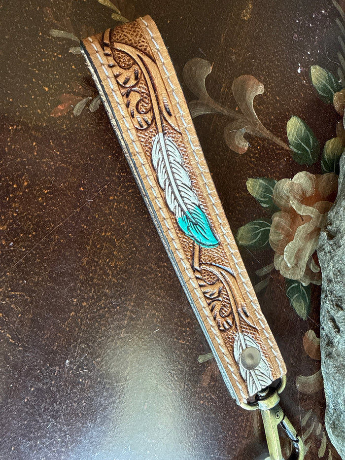 Cowhide wristlet keychain strap with turquoise feather motif and light-green metal ring