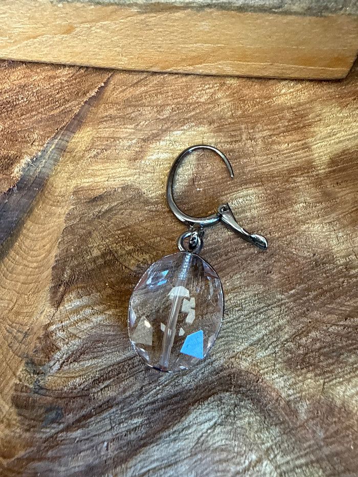 Silver-tone hoop hook earring with faceted clear oval crystal pendant and blue sheen