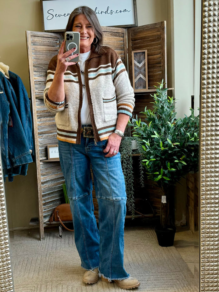 Tan cowboy cardigan with striped border, button front, and horse-and-cactus knit, full view