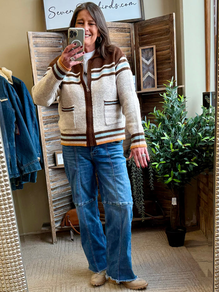 Tan button-front cardigan with striped yoke and horse-and-cactus graphic over jeans