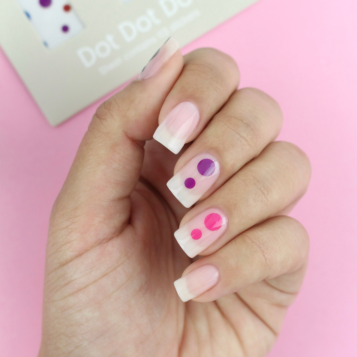 Dot Dot Dot polka dot decals on a sheer nude manicure with the packaging