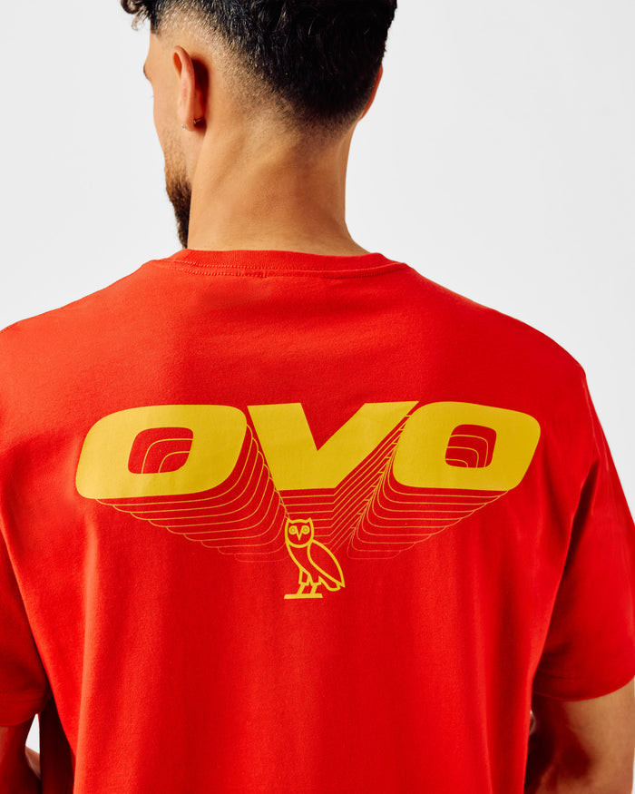 Red t-shirt with yellow "OVO" text and owl graphic printed on back.