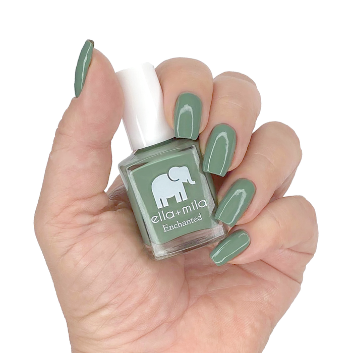 Evergreen muted evergreen nail polish manicure on a light skin tone with the bottle