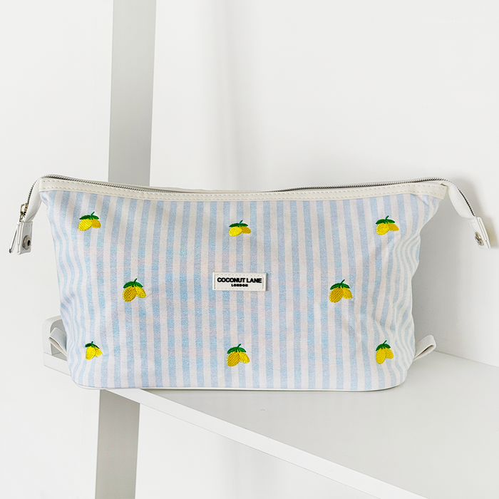 Coconut Lane expandable makeup bag in a lemon pattern on a white shelf.