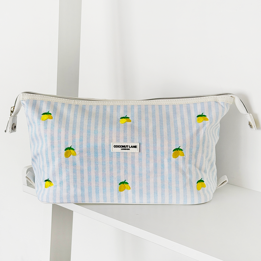 Coconut Lane expandable makeup bag in a lemon pattern on a white shelf.