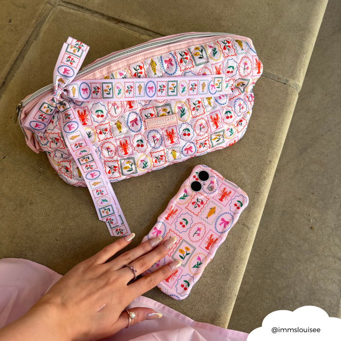 Quilted Dolce Vita makeup bag from Coconut Lane, expandable style, held by a hand with neutral-colored nails.