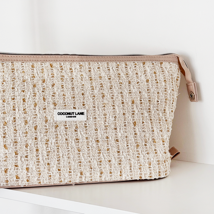 Vanilla tweed expandable makeup bag with textured finish by Coconut Lane on a white surface.