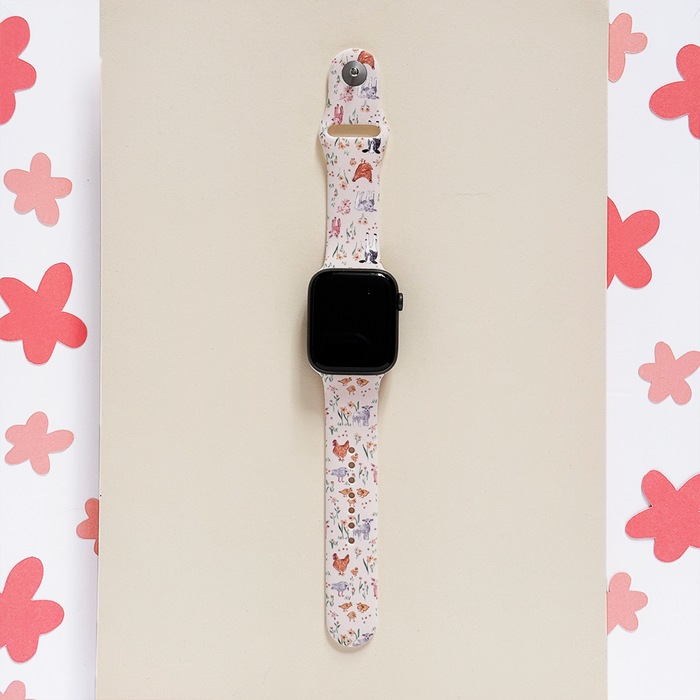 Coconut Lane Farmyard Friends Apple Watch strap with pastel animal prints on silicone and pink flower accents.