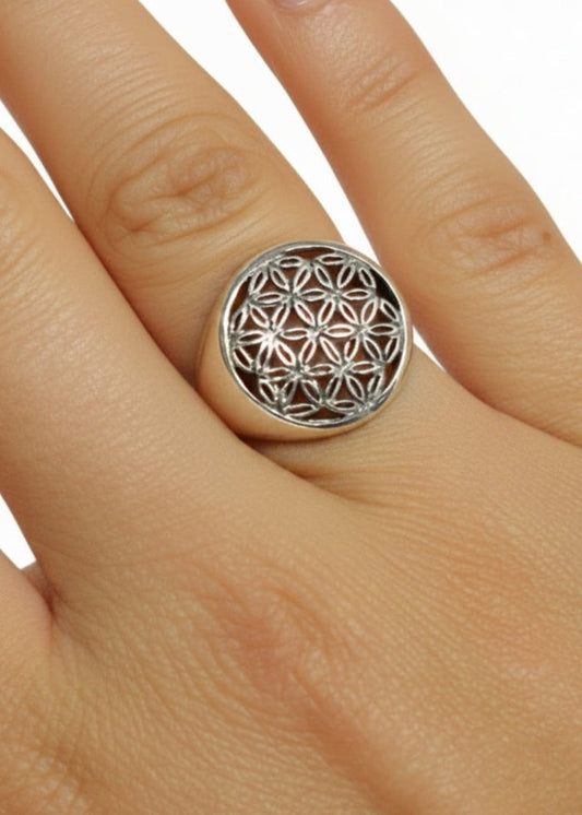 Model wearing Flower of Life ring in sterling silver with sacred geometry design, front view on hand