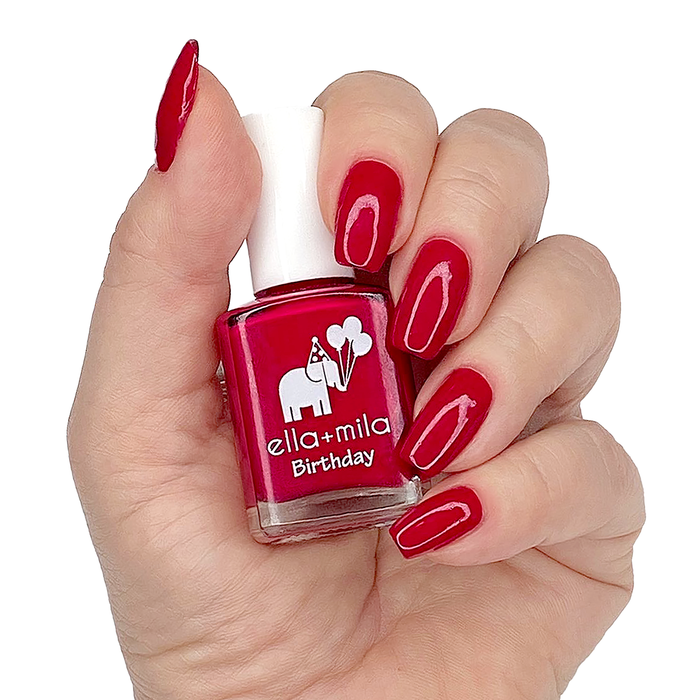 Fourth Wish true red nail polish manicure on a light skin tone with the bottle