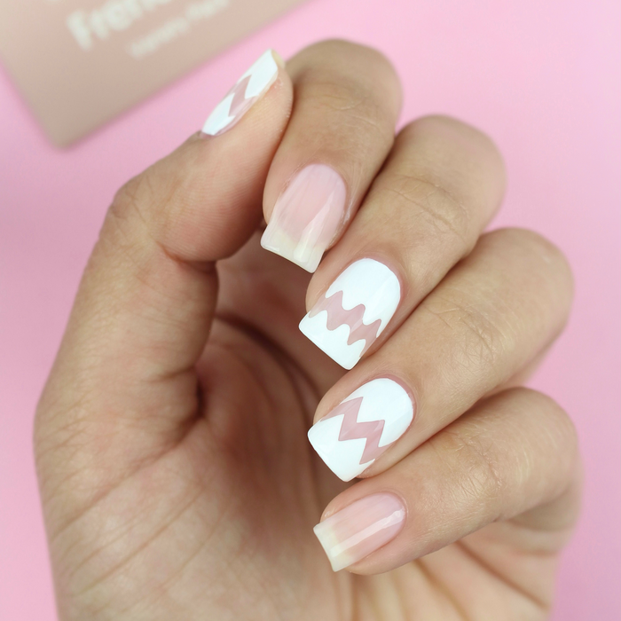 French Mani Strips white chevron French tips on a sheer nude manicure