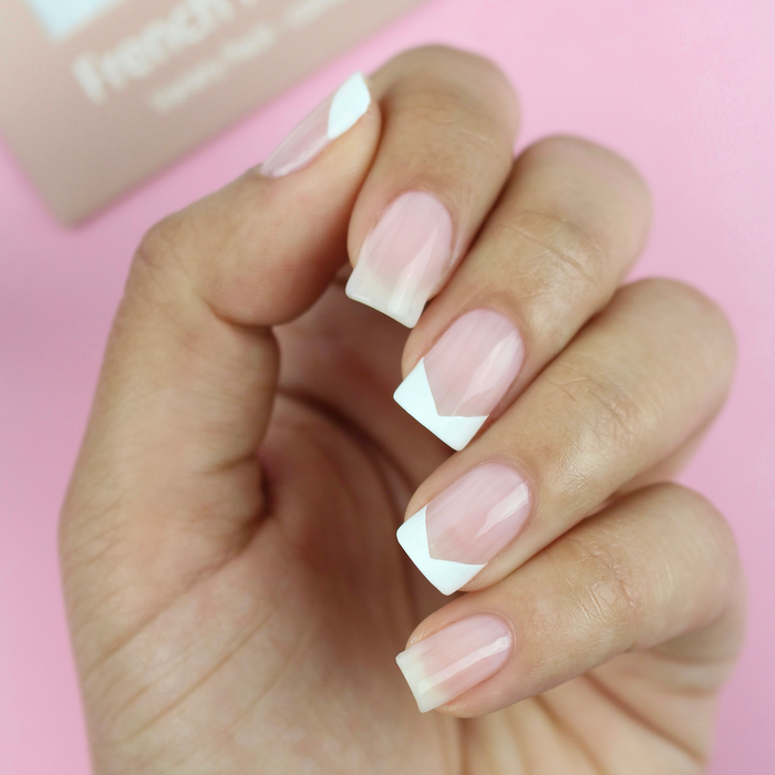 French Mani Strips curved white French tips on a sheer nude manicure