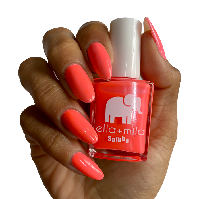 French Martini vibrant coral nail polish on a deep skin tone, hand holding the bottle