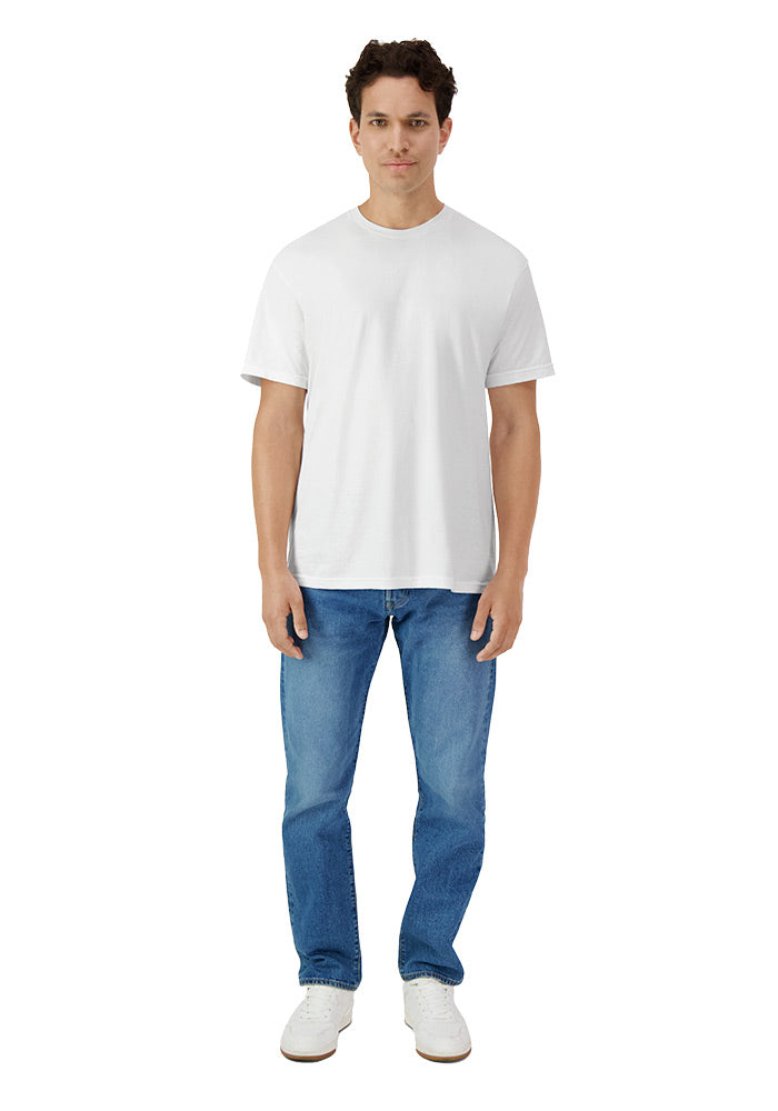 Man wearing a relaxed fit plain white short sleeved t-shirt and blue jeans on a white background