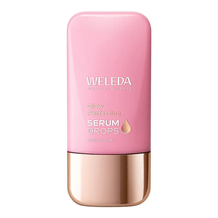 A pink bottle of Weleda Glow Perfecting Serum Drops with a metallic rose gold cap.