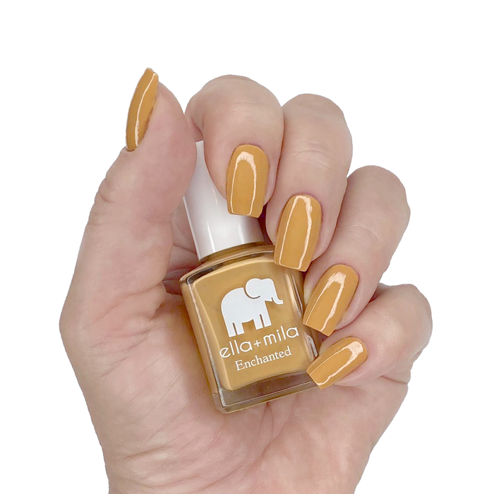 Goldie golden mustard nail polish manicure on a light skin tone with the bottle