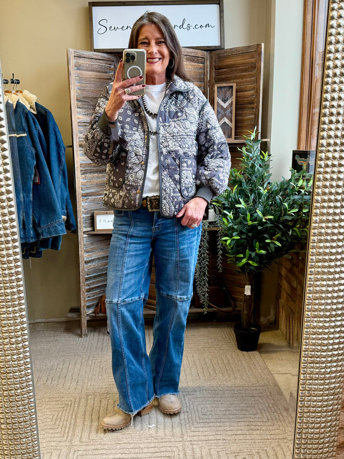 Quilted paisley coat with waist tie and pockets; long sleeves, dark with light motifs