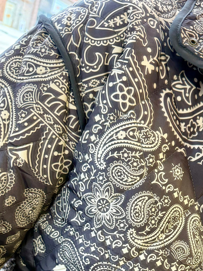 Quilted paisley coat front with stand collar, zipper, long sleeves; dark with white motifs