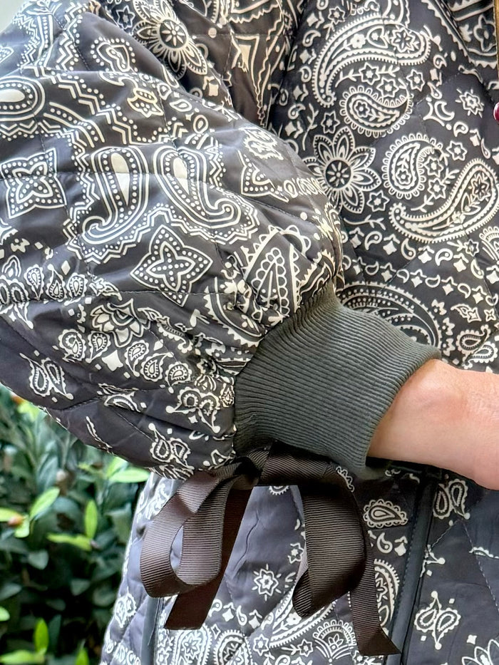 Quilted paisley coat with ribbed cuffs and waist tie, dark fabric with white patterns