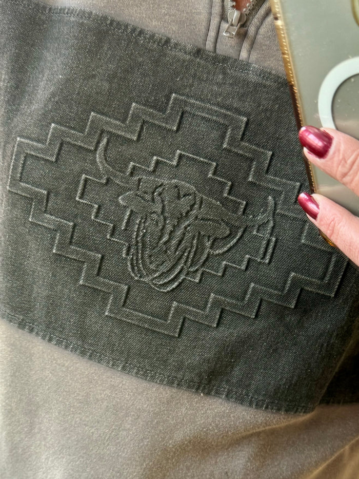 Steerhead emblem on dark gray sweatshirt chest with geometric stitch trim