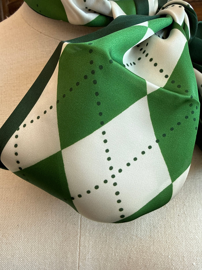Close-up of green and white argyle twilly scarf with dotted diamond pattern