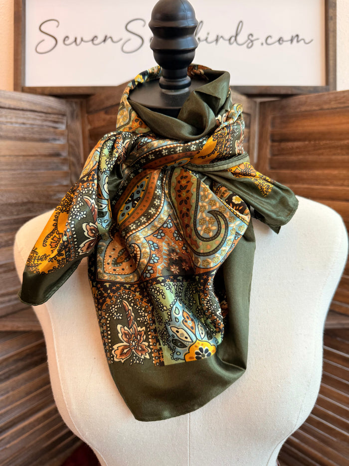 Wild rag scarf draped on a mannequin in multicolor paisley with olive backing