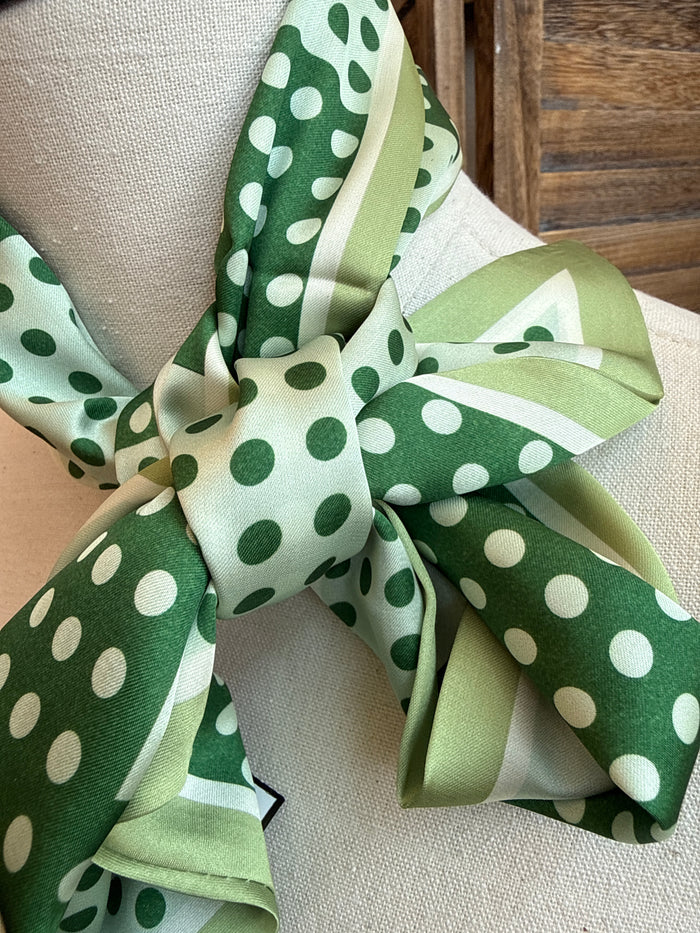 Green and white polka dot twilly scarf bow knot close-up