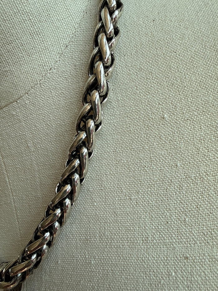Twisted metal chain necklace with interlocking links, silver tone