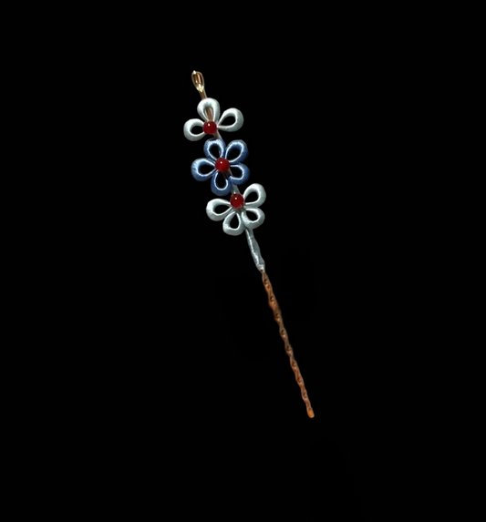 Close-up of delicate blue and silver layered flowers on handmade Chanhua hairpin
