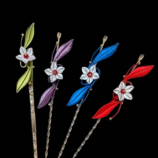 Close-up of a handmade Chanhua thread-wrapped "Bright Moon" hairpin featuring a blue spiral design, a white flower, and a red bead accent.