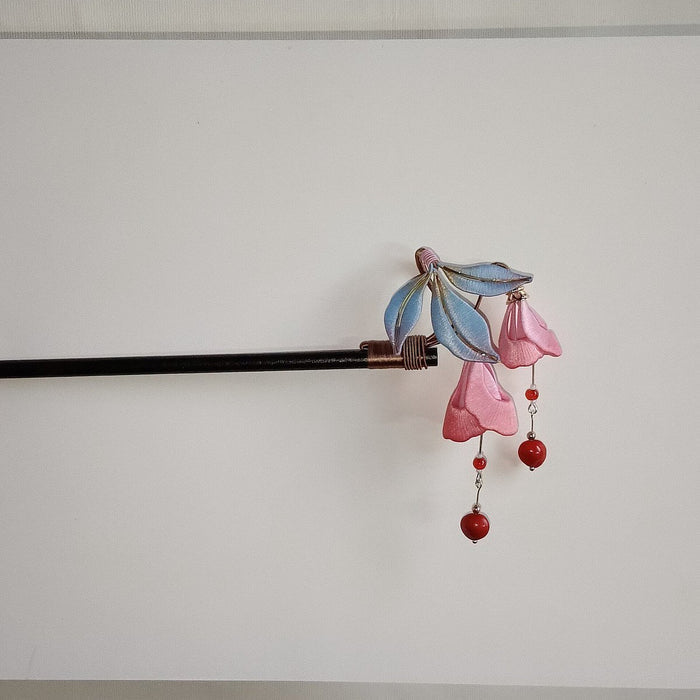 Handcrafted Chanhua thread-wrapped hairpin featuring pink Fuchsia blossoms, blue-gradient leaves, and red bead drops against a white background.
