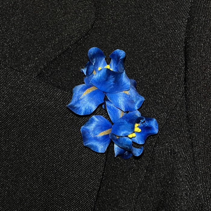 Handmade Ronghua royal blue iris brooch worn on black lapel – mulberry silk velvet flower pin