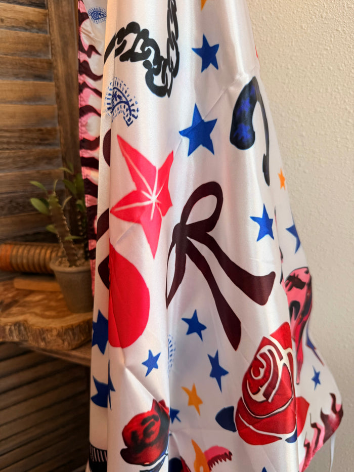 White wild rag scarf with blue stars, red accents, and stylized hearts