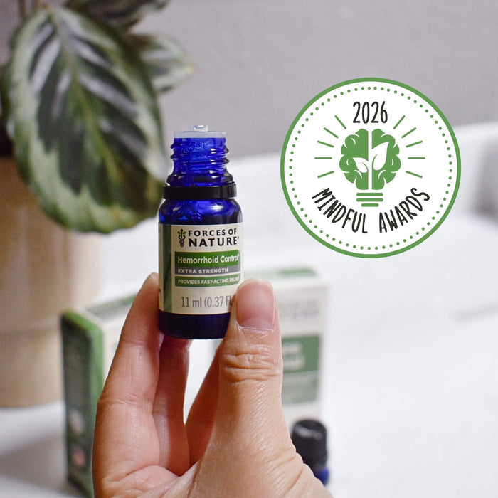 Front view of Hemorrhoid Control Extra Strength 11 ml bottle held between fingers showing label and 2026 Mindful Awards badge