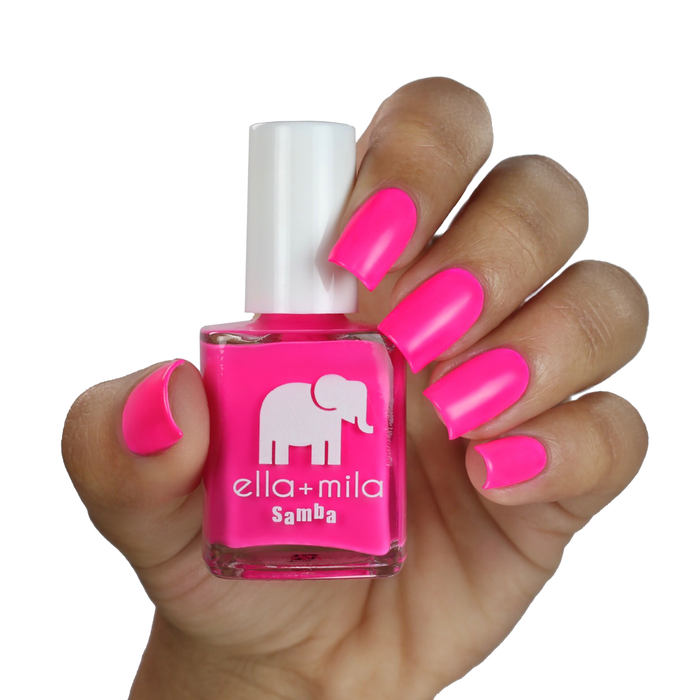 I Pink I Love You highlighter pink nail polish on a medium skin tone, hand holding the bottle