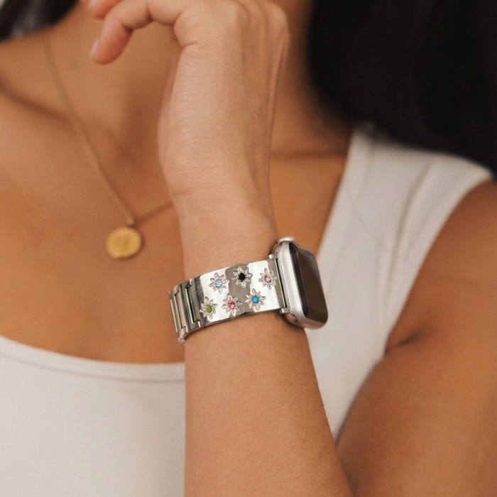 Person wearing Coconut Lane Ibiza Starlight coloured stone Apple Watch strap, gold pendant, and white top.