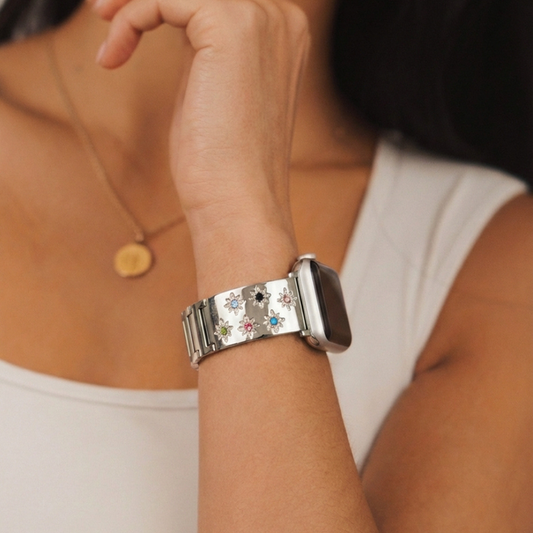 Person wearing Coconut Lane Ibiza Starlight coloured stone Apple Watch strap, gold pendant, and white top.