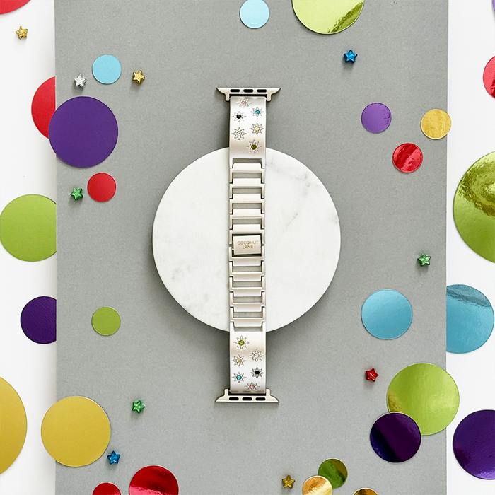 Starlight Ibiza coloured stone Apple Watch strap with stars, shown on a gray confetti background.